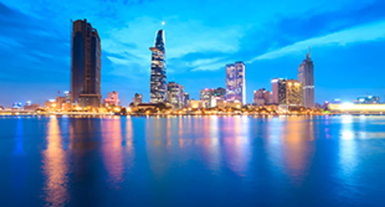 Downtown Saigon skyline in twilight with the sea in the foreground