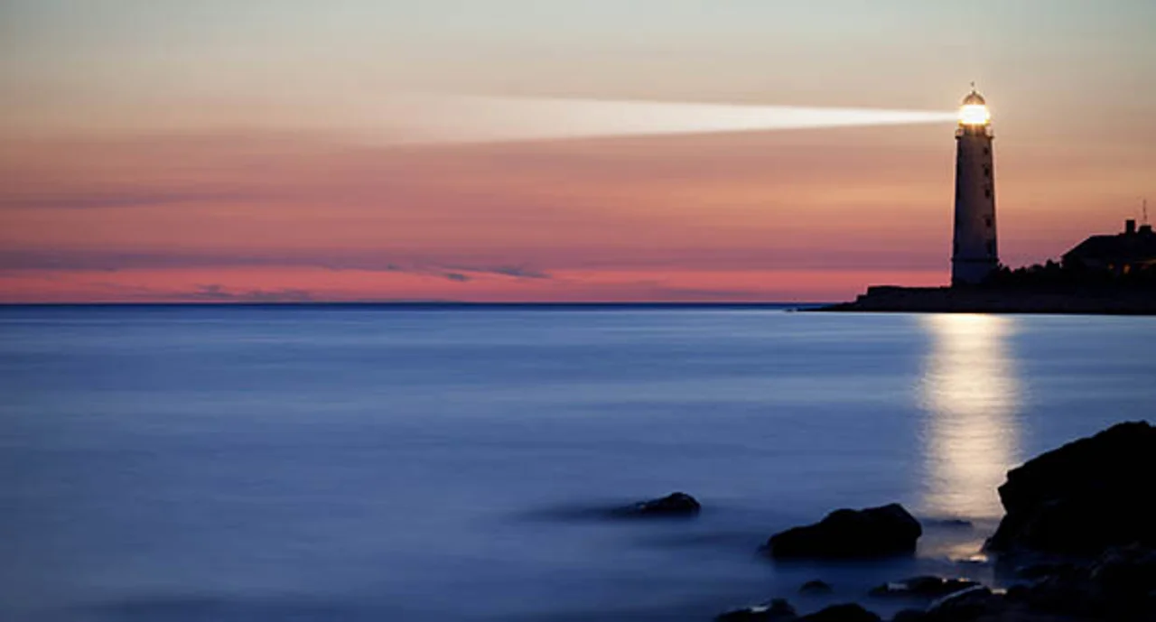 A lighthouse on the coast during dusk
