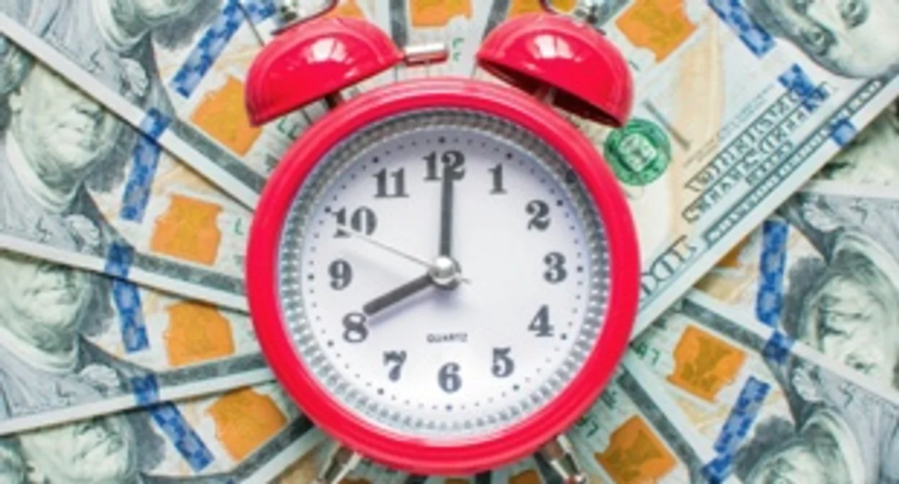 A layer of money with a clock in the middle