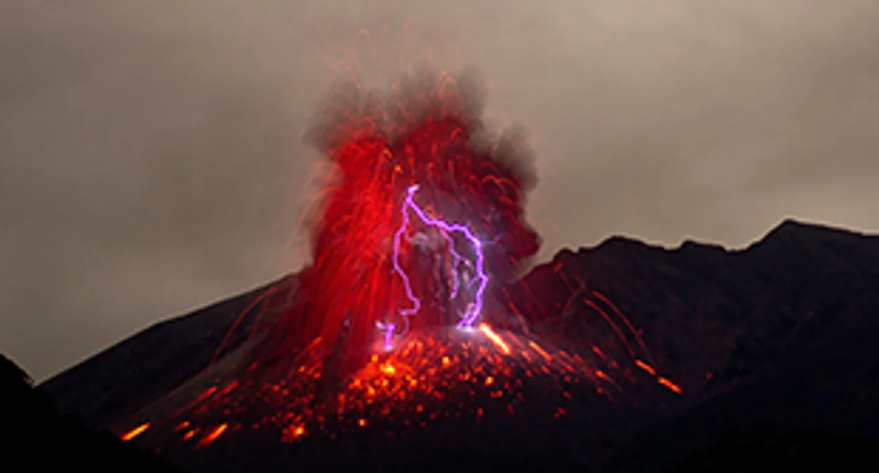 An erupting volcano in vivid red and with magenta lighting