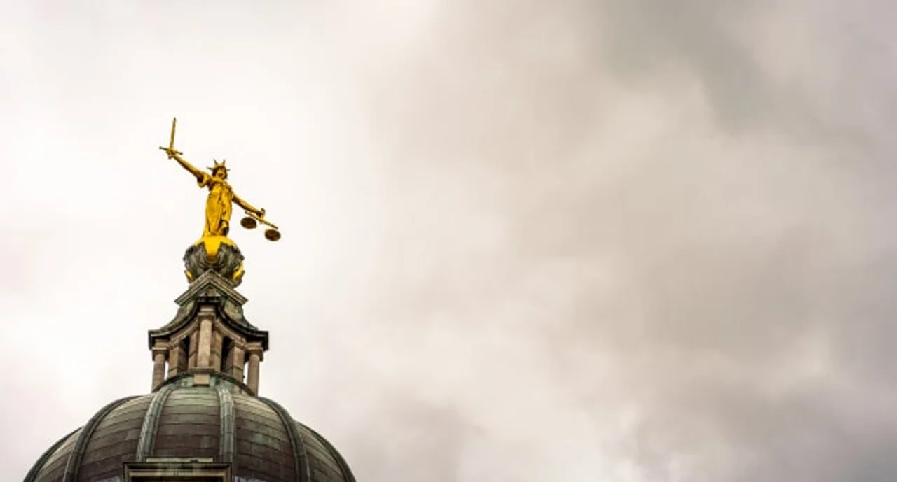 lady justice facing a stormy sky