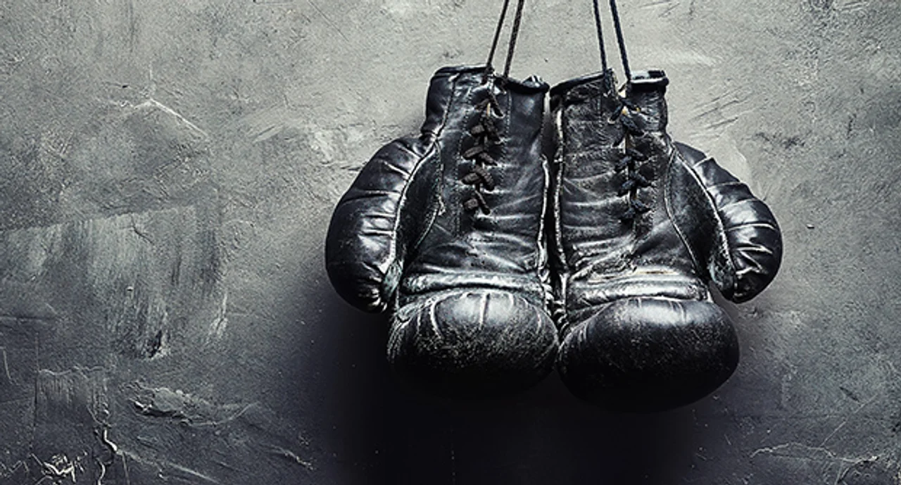 Old Boxing Gloves Nailed To The Textured Wall