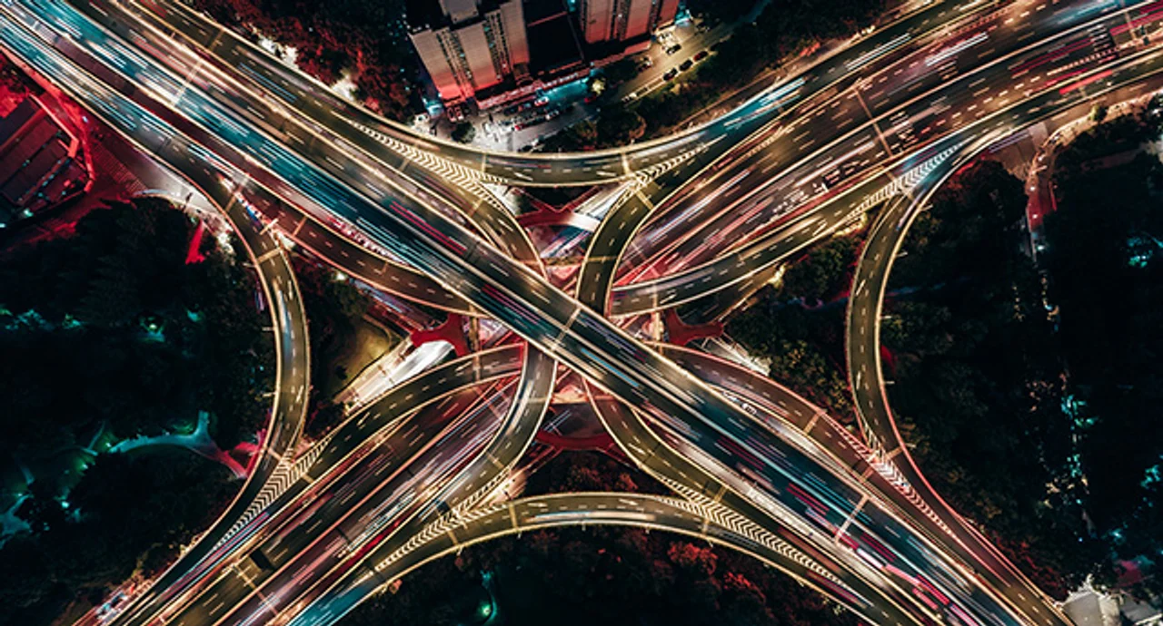 Drone aerial view of an overpass and city traffic at night
