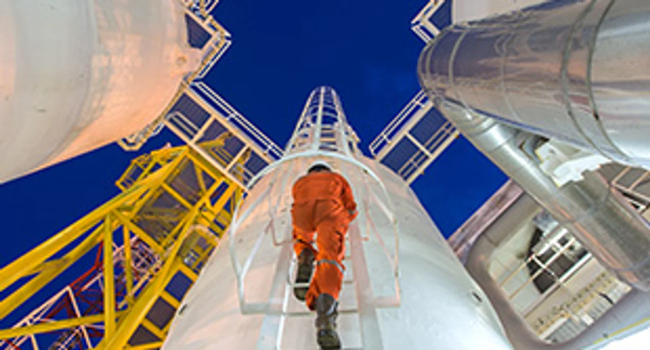 Engineering climb up to oil and gas process plant to observer gas dehydration processing in night shift