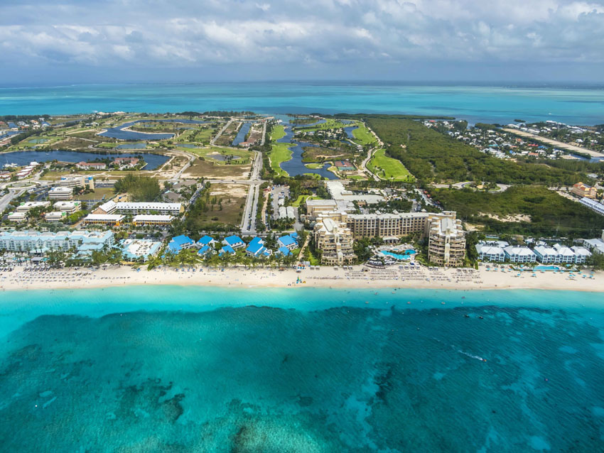 island with hotels and bright blue water in front and in the back